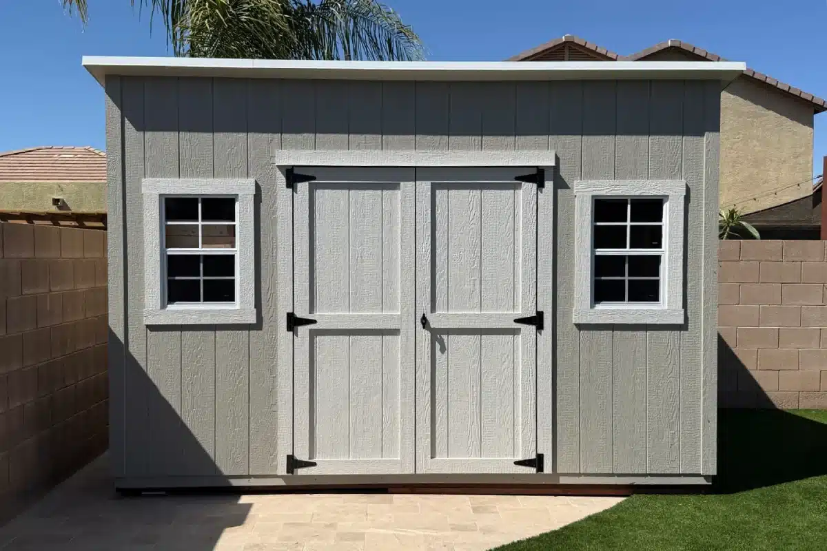 Front of a 12×8 Standard lean-to shed with white double doors and two windows, built in San Tan Valley, Arizona